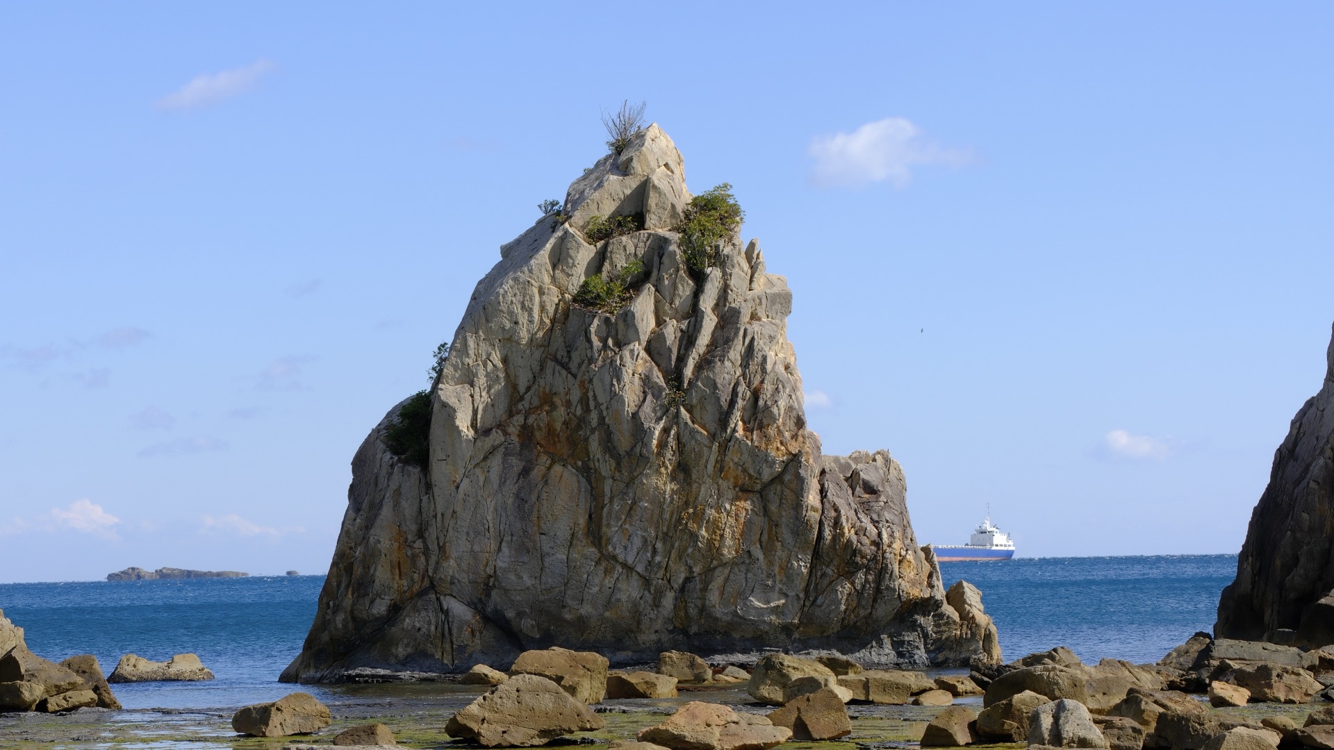 橋杭岩全景,數十根巨岩排列於退潮礁石灘